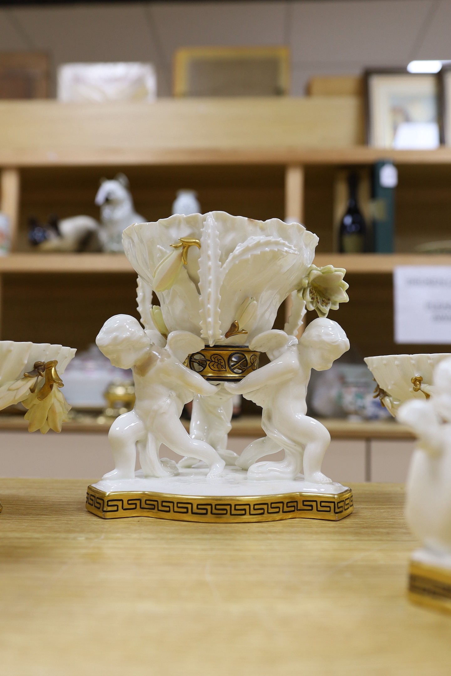 Six pieces of Moore Bros. white glazed gilt edged porcelain, including a set of four comport, 20cm tall